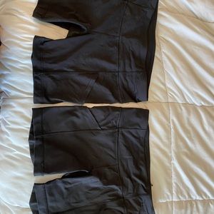 2 black Lululemon bikes shorts with pockets